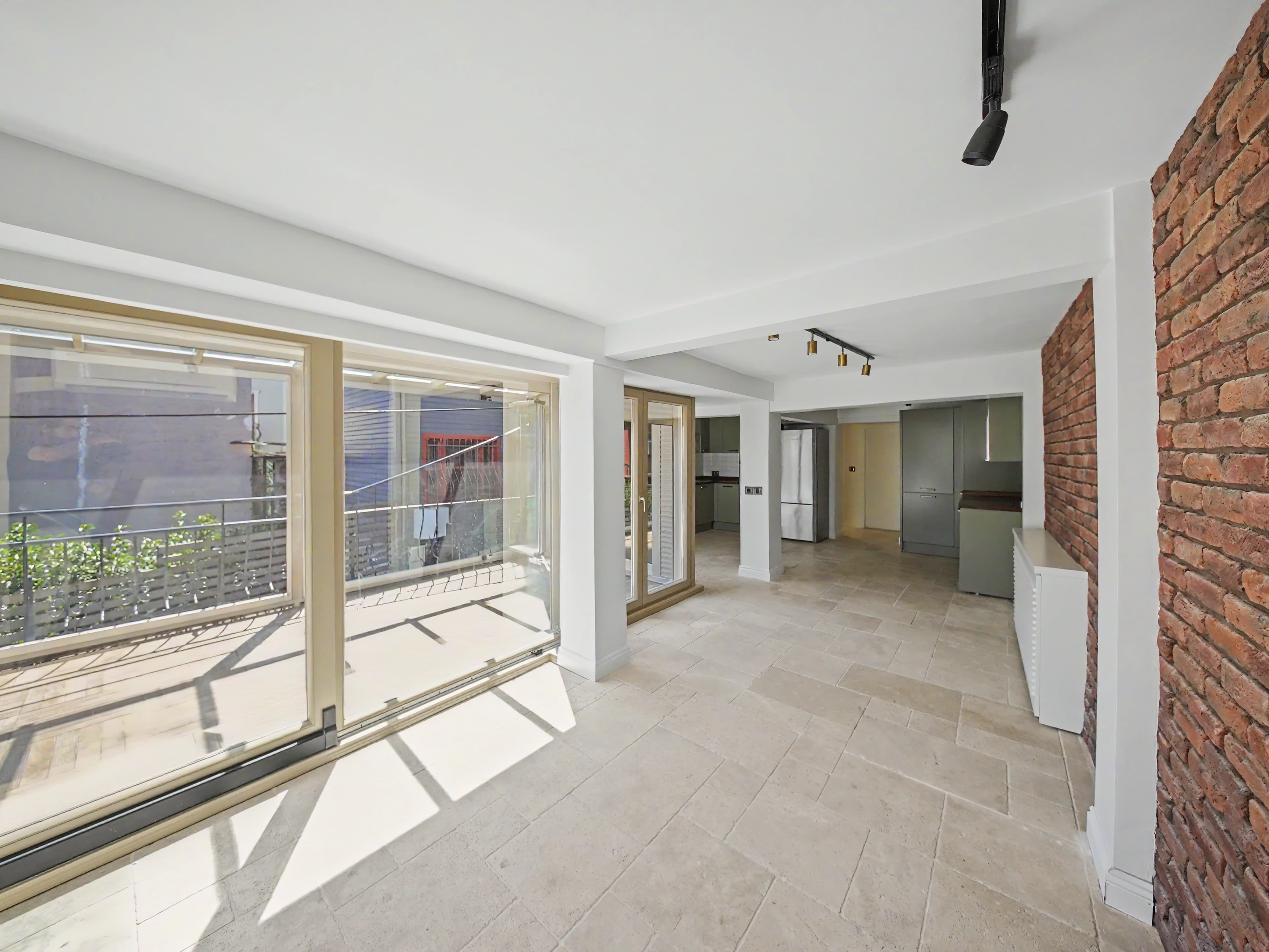 Living area opening toward the terrace inside a fully renovated Yenikoy villa